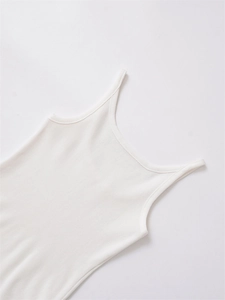 Flat lay of white ribbed knit camisole with thin straps and a wide U-neckline style
