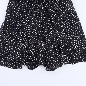 Classic black and white polka dot mini dress made of lightweight flowing chiffon fabric