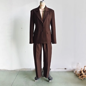 Deep brown women's two-piece business suit featuring a fitted blazer and straight trousers