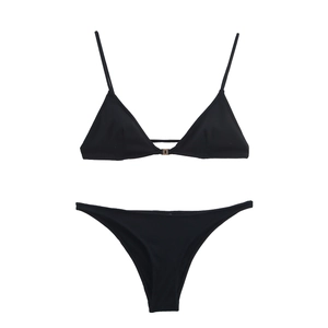 Detailed flat lay of black triangle bikini set featuring elegant gold metal clasp details