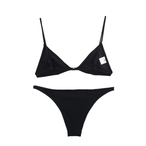 Close-up of black triangle bikini set with white size tag showing detailed fabric texture