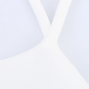 Detail shot of the white tiered halter dress showing breathable fabric and strap stitching