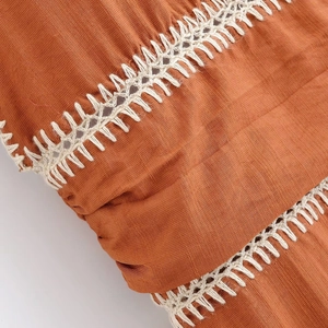 Chic halter neck caramel dress featuring white ladder stitch crochet and linen texture