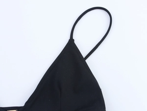 Detail shot of thin straps and V-neckline stitching on a black triangle bikini top