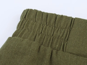 Vue macro détaillée de la taille élastique d'un pantalon en lin vert foncé