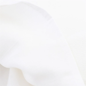 Detail of clean stitching and fine fabric texture on white halter neck dress