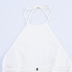 Detail of white halter neck dress featuring slim straps and a metallic buckle closure