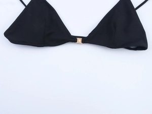 Close-up of black triangle bikini top featuring a central golden square metal buckle