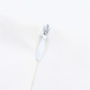Detailed close-up of a white invisible zipper with a teardrop pull on high-quality fabric