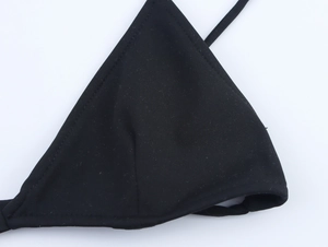 Close-up of black triangle bikini top cup with textured fabric and fine stitching