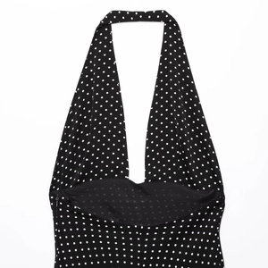 Sleeveless black polka dot halter neck dress for women with a deep V-neckline