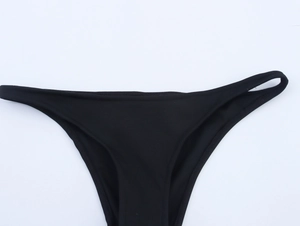 Detail of black high-elastic bikini bottoms with slim waist strap and clean stitching