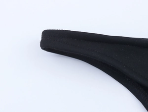 Close-up of black bikini fabric showing high-quality double stitching and texture