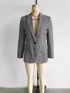 Detailed view of women's classic houndstooth blazer with single button and flap pockets