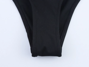 Close-up detail of reinforced double-needle stitching on the black bikini bottom crotch