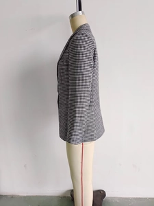 Side view of houndstooth blazer showing notched lapel and tailored waist on mannequin
