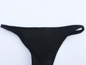 Close-up of black bikini bottoms featuring smooth fabric texture and fine stitching detail