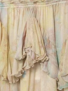 Close-up of layered chiffon skirt with tie-dye print and ruffled edge details
