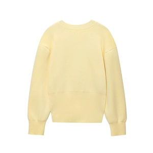Detail of light yellow knit cardigan featuring long ribbed cuffs and wide waist stitching