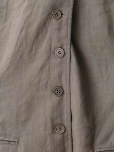 Detailed macro view of the natural linen texture and vertical buttons on the taupe skirt set