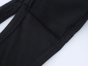 Detailed close-up showing stitching and texture of black triangle bikini fabric