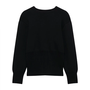 Detailed view of the ribbed knit cuffs and hem on this black round neck sweater