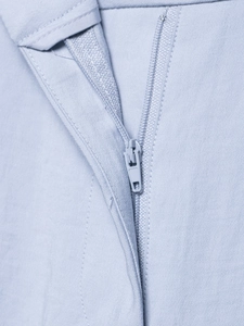 Detail showing the seamless hidden zipper on high-quality light blue twill fabric