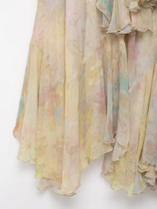 Detail of layered floral chiffon skirt featuring asymmetric ruffles and watercolor print