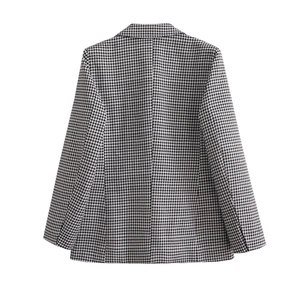 Detailed back view showing black and white houndstooth pattern of a tailored suit jacket
