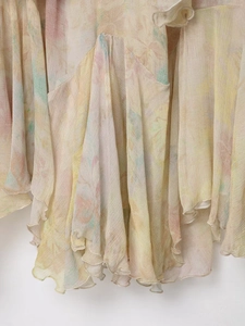 Detailed macro view of layered chiffon fabric with delicate floral watercolor pattern