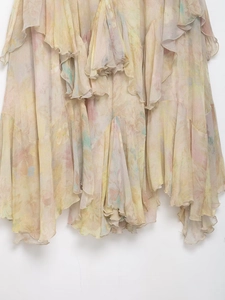 Detail of layered ruffle tiers and floral print on lightweight cream chiffon skirt