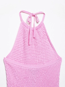 Detail of pink halter neck knit dress with textured waffle weave fabric and tie straps