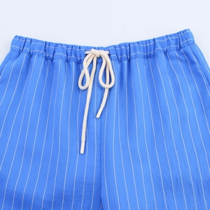 Close-up of blue vertical striped casual shorts with elastic waistband and cotton drawstring