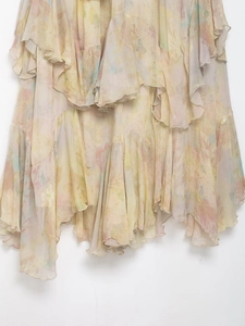 Detail of layered ruffle hem on floral chiffon skirt with pastel meadow print design