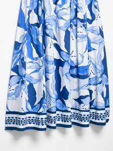 Detailed blue and white floral print on a cotton midi dress with geometric hem pattern