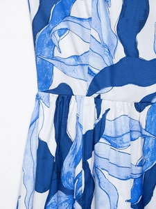 Detail of blue botanical floral print and pleated waist on white summer midi dress