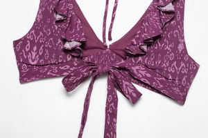Detail of ruffle neckline and tie-knot bow on purple paisley print tankini top