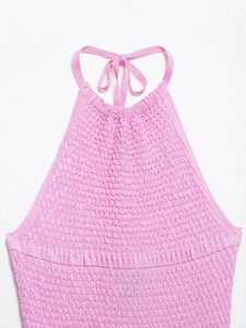 Close-up of pink knit halter top featuring a detailed textured diamond crochet pattern