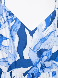 Close-up of deep V-neckline and blue floral print on white summer dress fabric