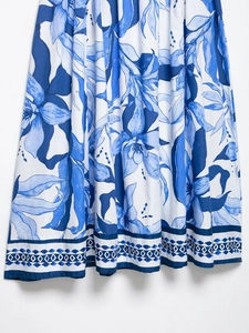 Detailed view of the blue and white floral print hem with geometric border patterns