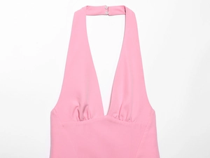 Detail view of the halter neck clasp and deep V-neckline on this pink summer midi dress