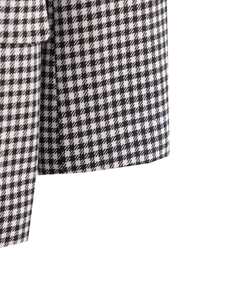 Close-up of black and white houndstooth fabric texture for women's blazer jacket