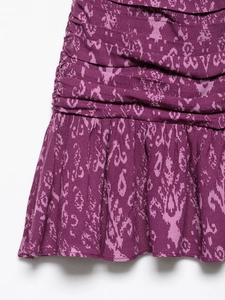 Detailed macro shot of purple abstract ikat print fabric with ruching and ruffle hem detail