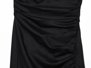 Detail shot of black dress fabric with side ruching and subtle textured matte finish