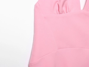 Close-up of pink elegant dress showing pleated chest detail and soft textured fabric
