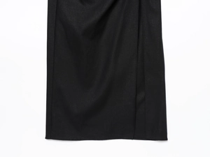 Detail of black midi dress showing twill fabric texture and elegant side slit design
