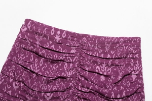 Detail view of purple floral print fabric with vertical ruched design and layered texture