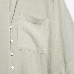 Minimalist light green linen shirt dress with square chest pocket and pearlescent buttons