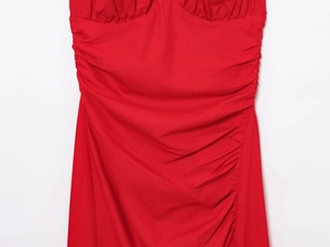 Detailed macro view of the ruched texture and fabric stitching on a red midi dress