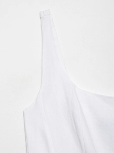 Detailed macro view of white linen midi dress straps and premium woven fabric texture